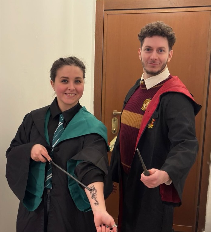 In Hogwarts robes, being a Potterhead